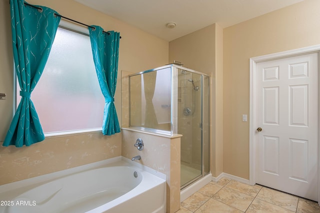 bathroom with a bath, tile patterned flooring, and a stall shower