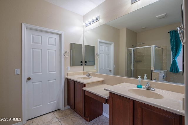 bathroom with a shower stall, double vanity, and a sink