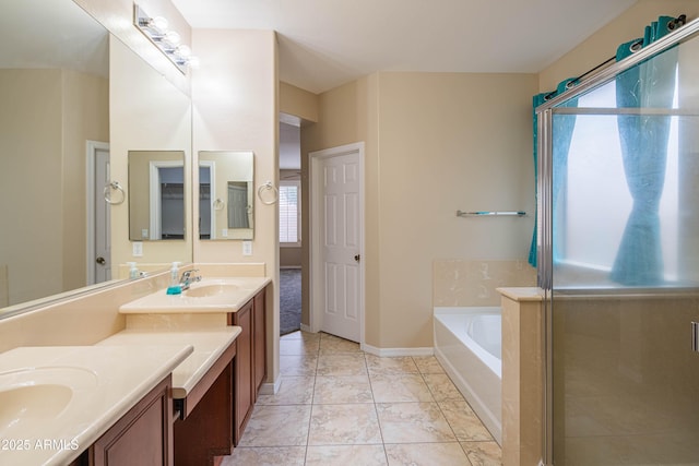 full bathroom with vanity, baseboards, a shower stall, a garden tub, and tile patterned floors