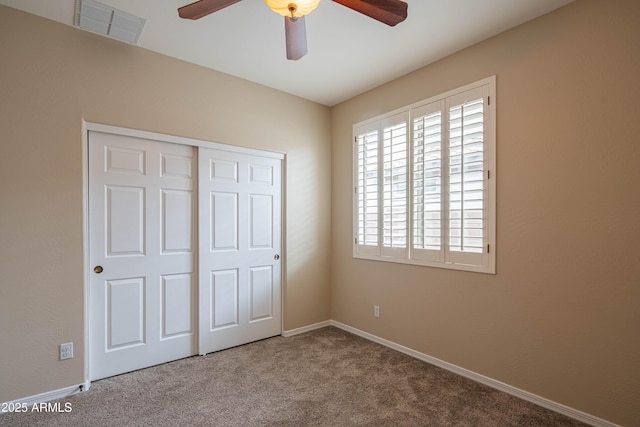 unfurnished bedroom with baseboards, visible vents, carpet floors, and a closet