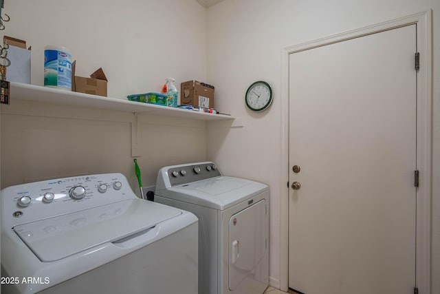 washroom featuring laundry area and washing machine and clothes dryer