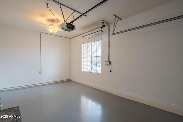 garage with a garage door opener and baseboards