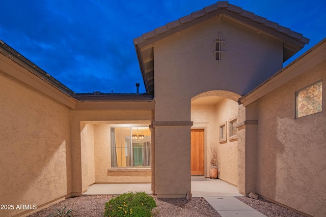 property entrance with stucco siding