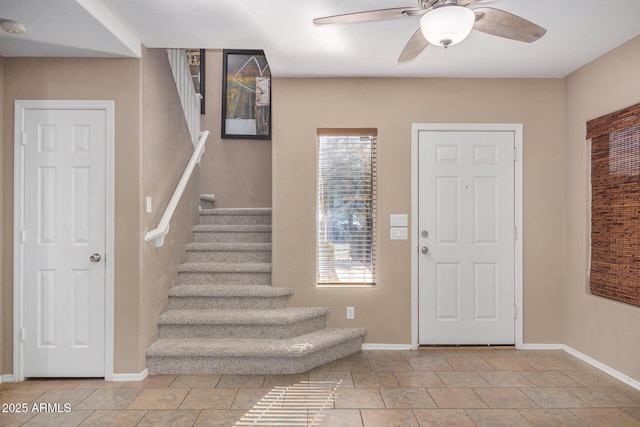 foyer entrance with ceiling fan