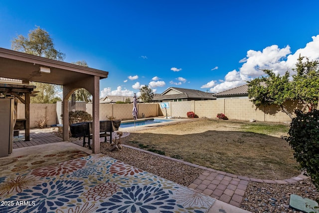 view of yard with a fenced in pool and a patio area