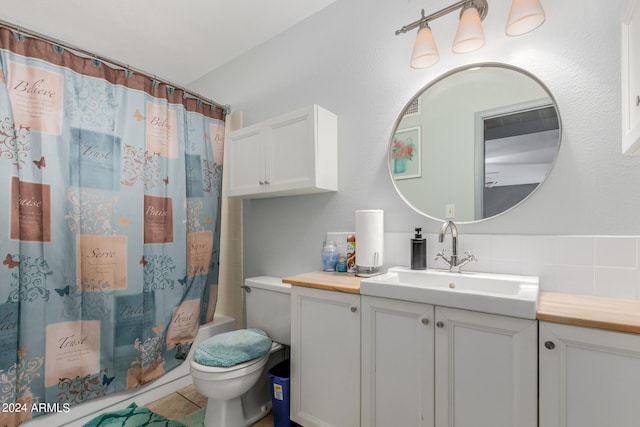 full bathroom featuring decorative backsplash, toilet, tile patterned flooring, vanity, and shower / bath combo