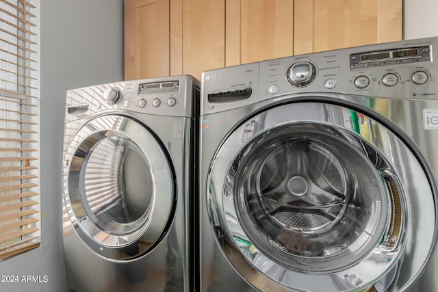 clothes washing area with washing machine and clothes dryer