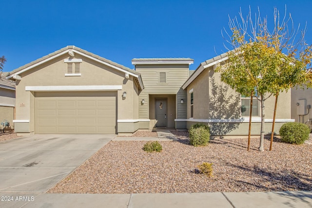 single story home featuring stucco siding, a garage, driveway, and a tile roof