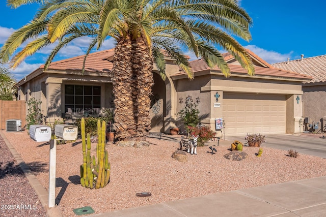 view of front of house featuring central air condition unit and a garage