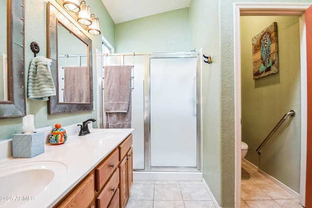 bathroom featuring toilet, lofted ceiling, tile patterned floors, and a shower with shower door