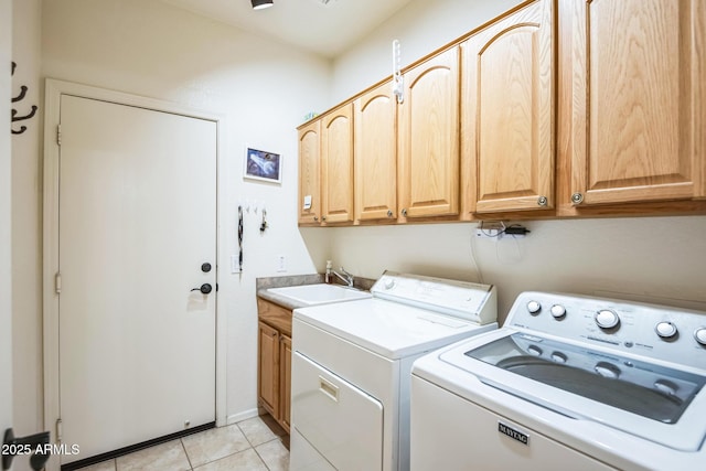 laundry room featuring cabinets, sink, light tile patterned floors, and washer and dryer