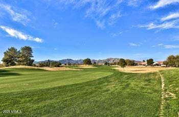 view of property's community featuring a mountain view and a lawn