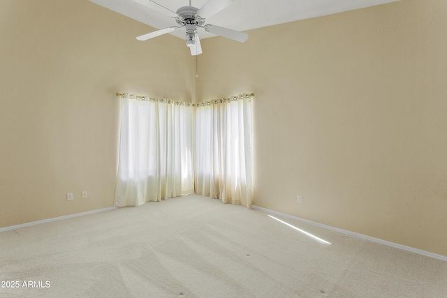 carpeted spare room with baseboards and ceiling fan