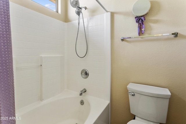 bathroom featuring toilet, bathing tub / shower combination, and a textured wall