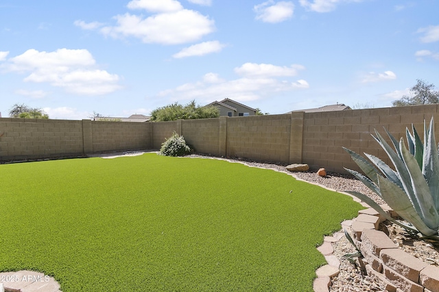 view of yard with a fenced backyard