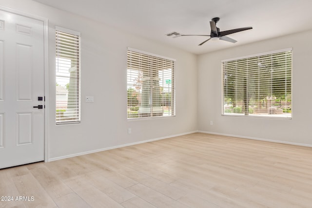 foyer entrance featuring ceiling fan, a wealth of natural light, and light hardwood / wood-style floors