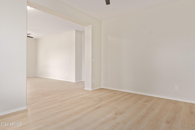 spare room with light hardwood / wood-style flooring and ceiling fan