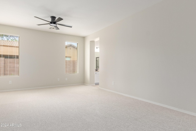 empty room with ceiling fan and carpet