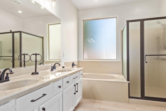 bathroom with separate shower and tub, hardwood / wood-style flooring, and vanity