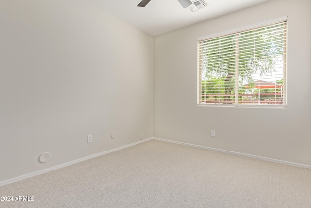 empty room featuring ceiling fan and carpet floors