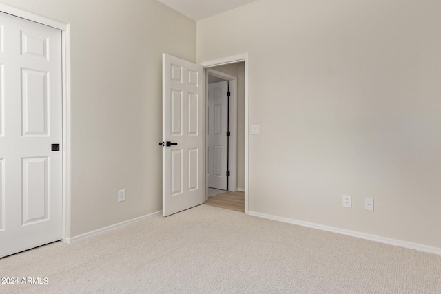 unfurnished bedroom with light colored carpet