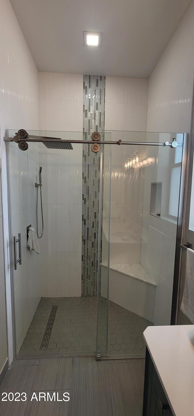 bathroom with tile floors and a shower with door