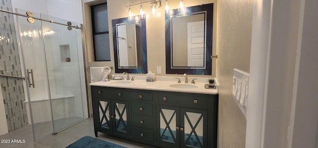 bathroom with tile floors, a shower with door, and dual vanity