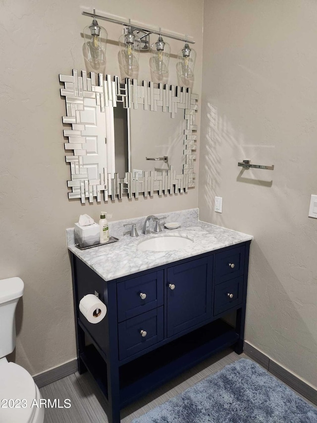 bathroom featuring toilet and vanity