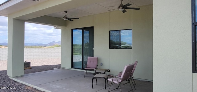 view of terrace featuring a mountain view and ceiling fan