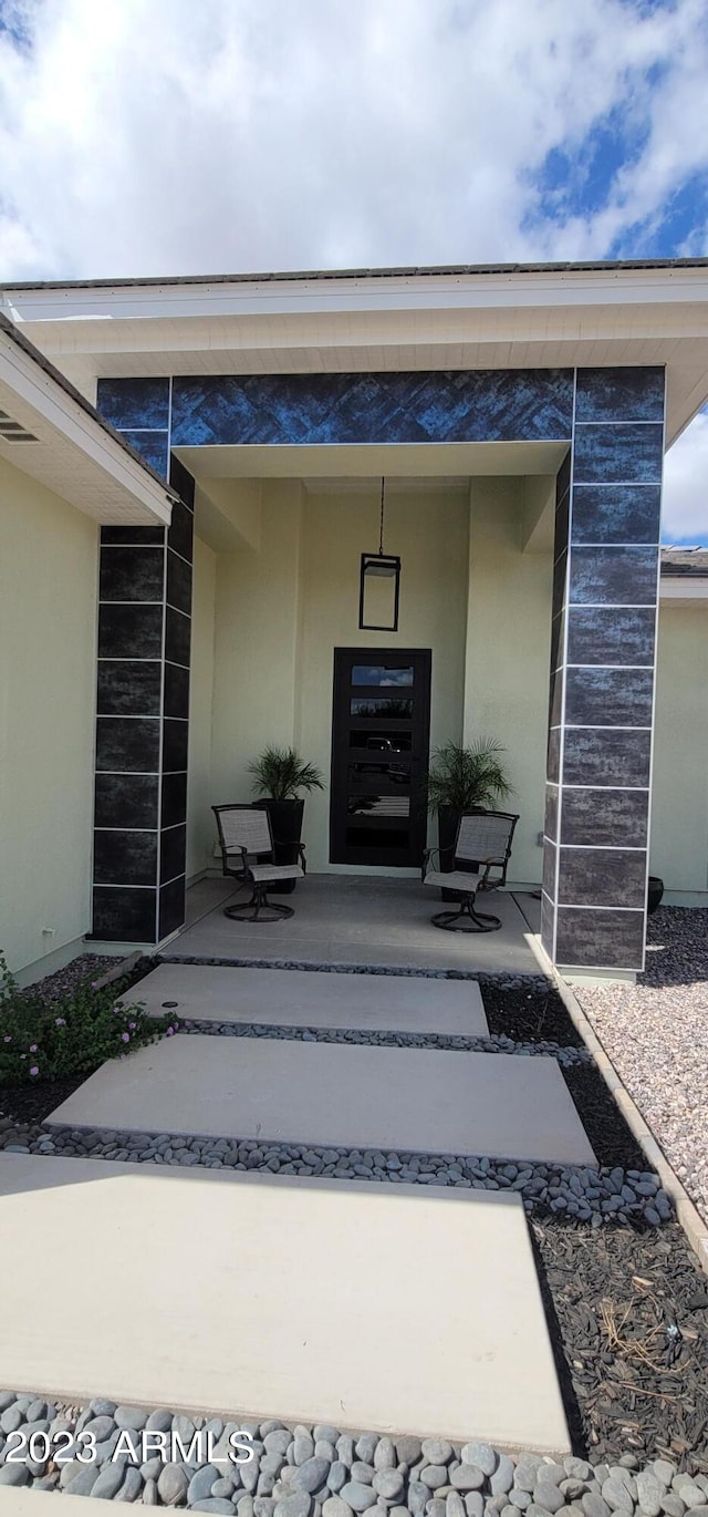 entrance to property with a patio area