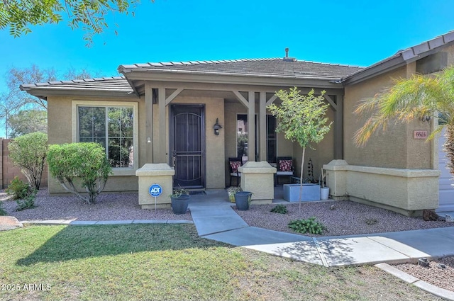 doorway to property with a lawn