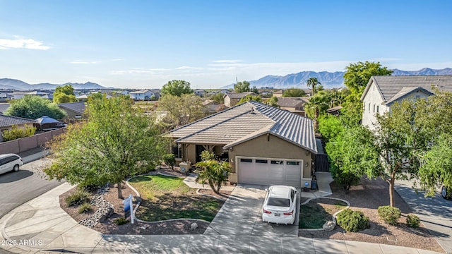 single story home featuring a garage and a mountain view