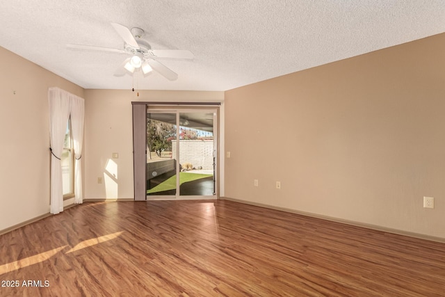 unfurnished room with ceiling fan, wood-type flooring, and a textured ceiling