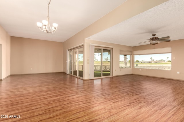 unfurnished room with ceiling fan with notable chandelier, light hardwood / wood-style floors, and a textured ceiling