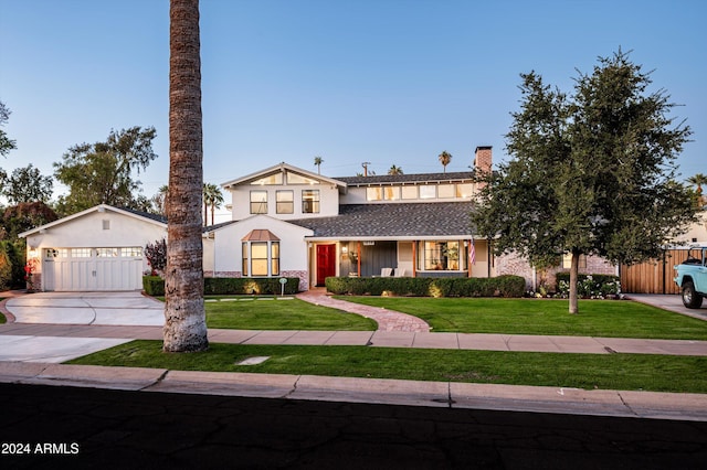 view of front of home featuring a front yard and a garage