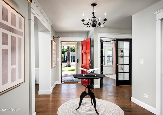 entrance foyer with a chandelier, french doors, dark hardwood / wood-style flooring, and plenty of natural light