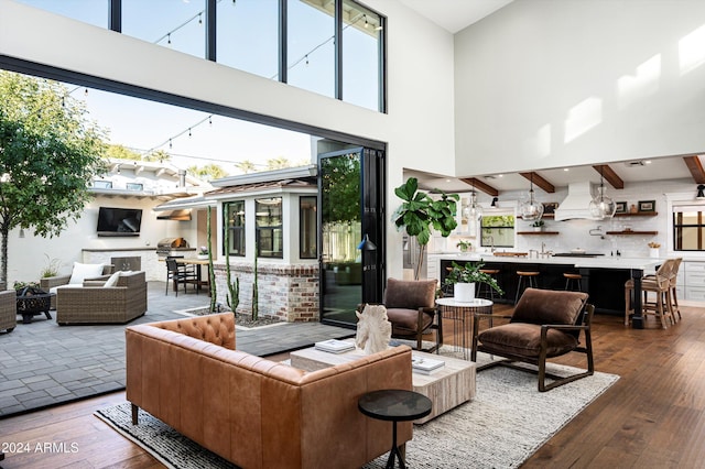 living room featuring dark hardwood / wood-style floors and a towering ceiling