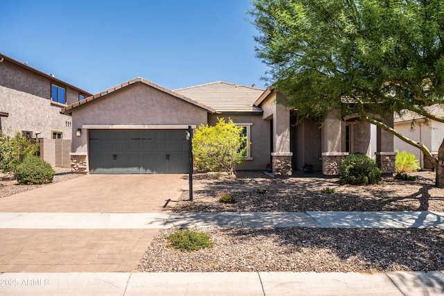 3022 E Santa Fe Ln, Gilbert, AZ 85297 - ranch-style house with stone siding, an attached garage, stucco siding, and a tiled roof