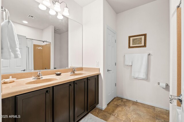 3022 E Santa Fe Ln, Gilbert, AZ 85297 - full bathroom with double vanity, a shower, and stone finish floors
