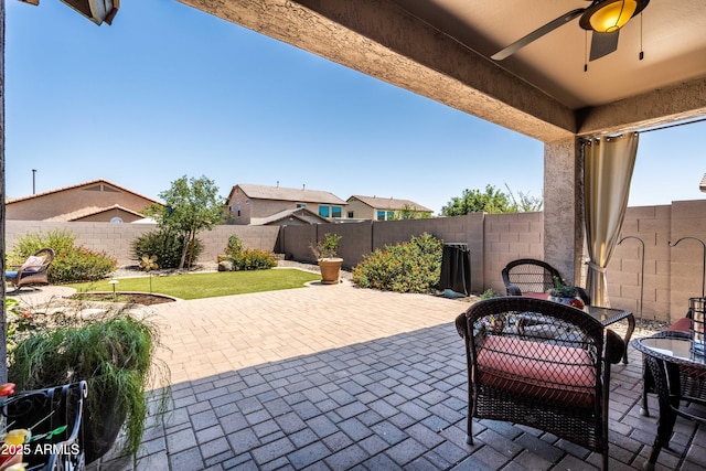 3022 E Santa Fe Ln, Gilbert, AZ 85297 - fenced backyard with a ceiling fan, outdoor dining space, and a patio