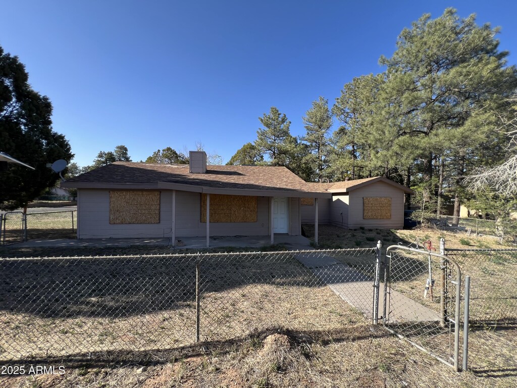 140 E Ellsworth, Show Low, AZ 85901 - view of front of house with a chimney and a gate