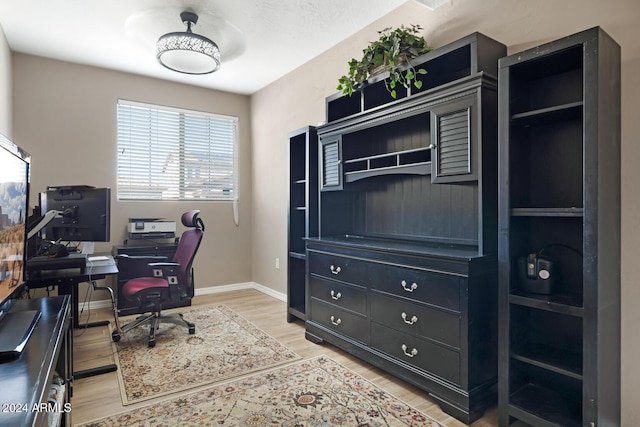 office space with light wood finished floors and baseboards