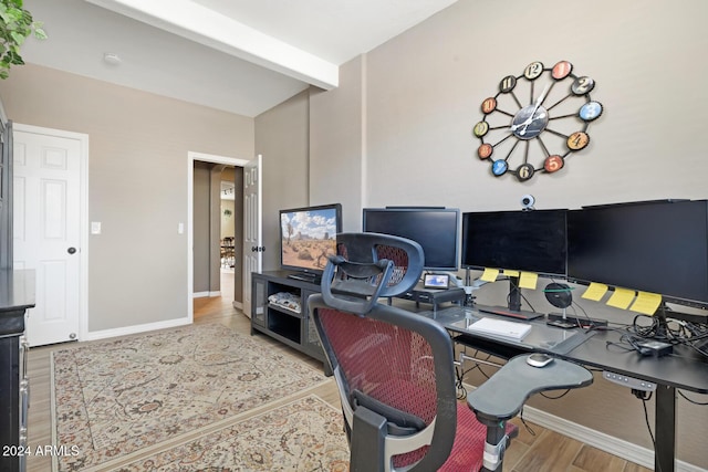 home office featuring beam ceiling, wood finished floors, and baseboards