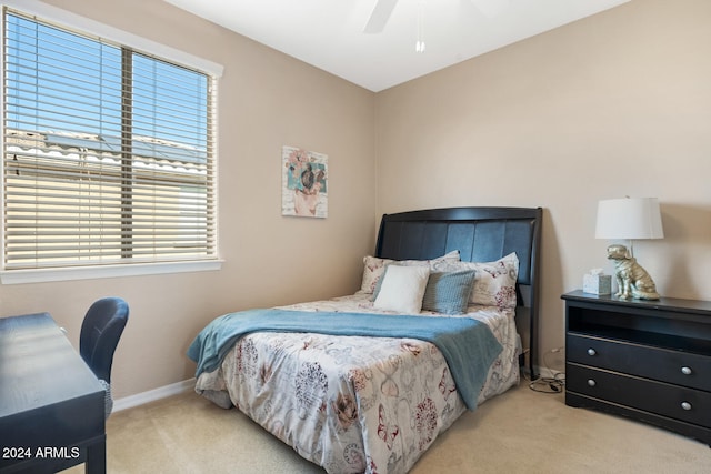 bedroom with multiple windows, light colored carpet, and ceiling fan