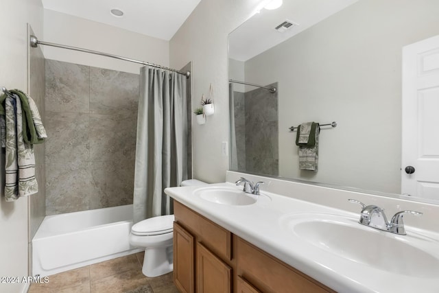 bathroom featuring toilet, shower / bath combo with shower curtain, double vanity, and tile patterned floors