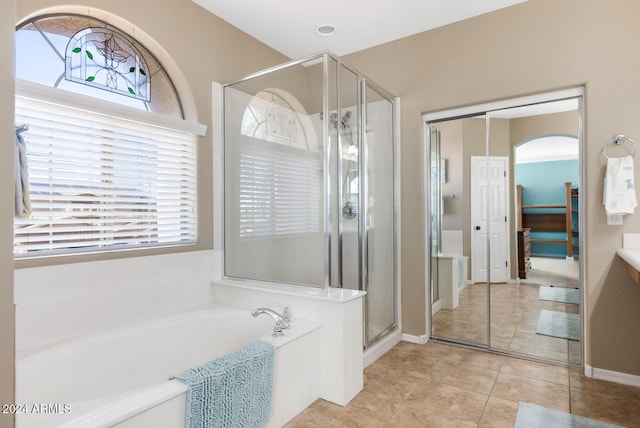 bathroom featuring independent shower and bath and tile patterned flooring