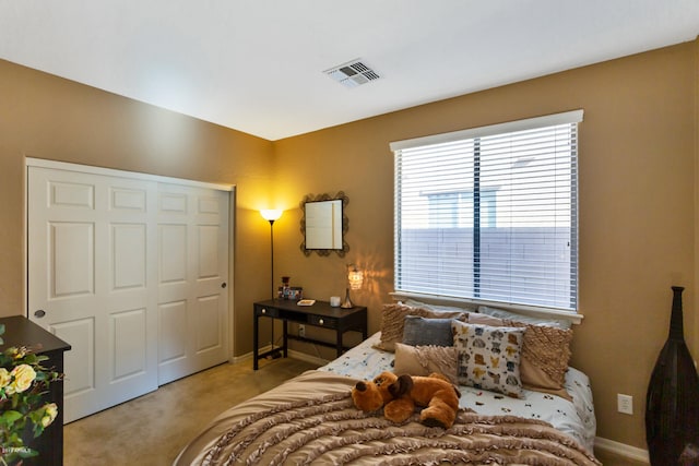 bedroom with light carpet and a closet