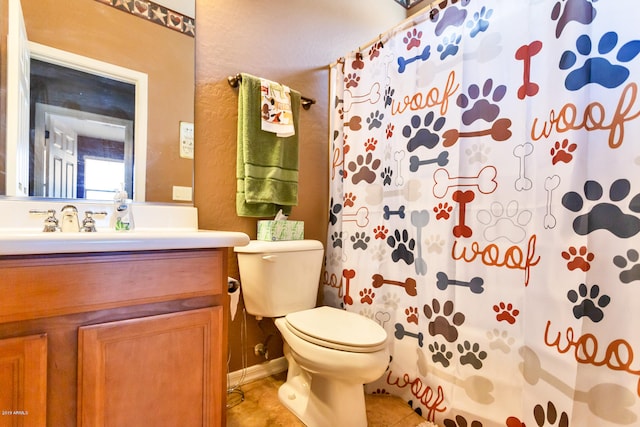 bathroom with toilet, vanity, tile patterned floors, and a shower with shower curtain