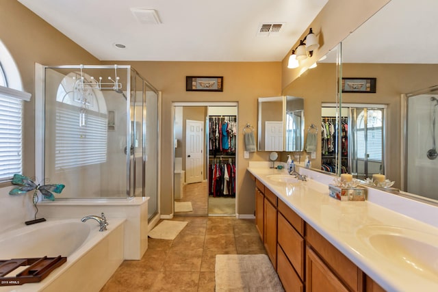 bathroom featuring vanity, tile patterned floors, separate shower and tub, and a wealth of natural light