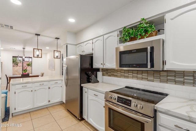 kitchen with stainless steel appliances, pendant lighting, white cabinets, and kitchen peninsula